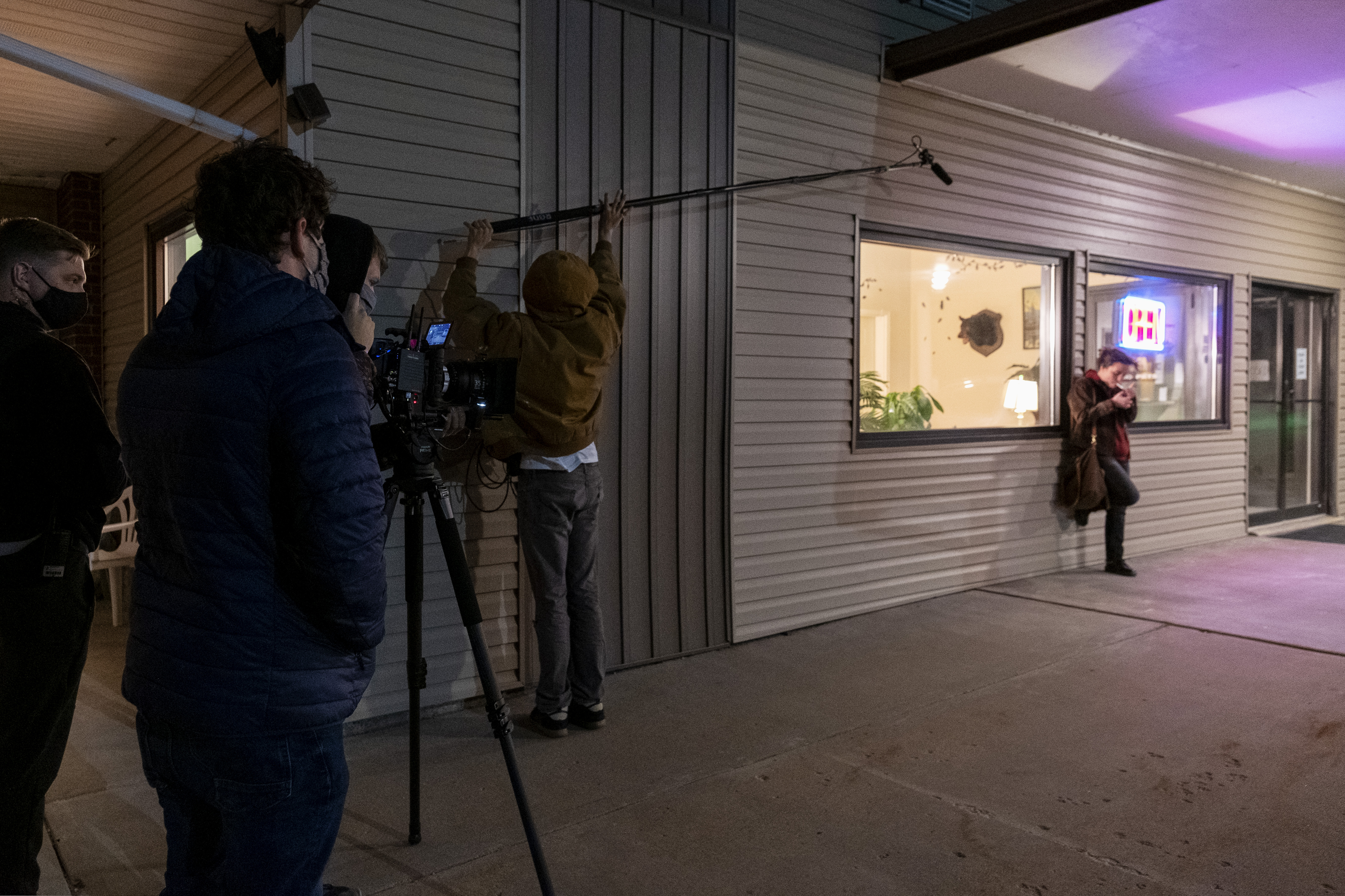 The crew films Cassie smoking a cigarette outside the motel